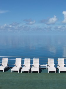 a calm blue ocean and sun beds, relaxation and peace